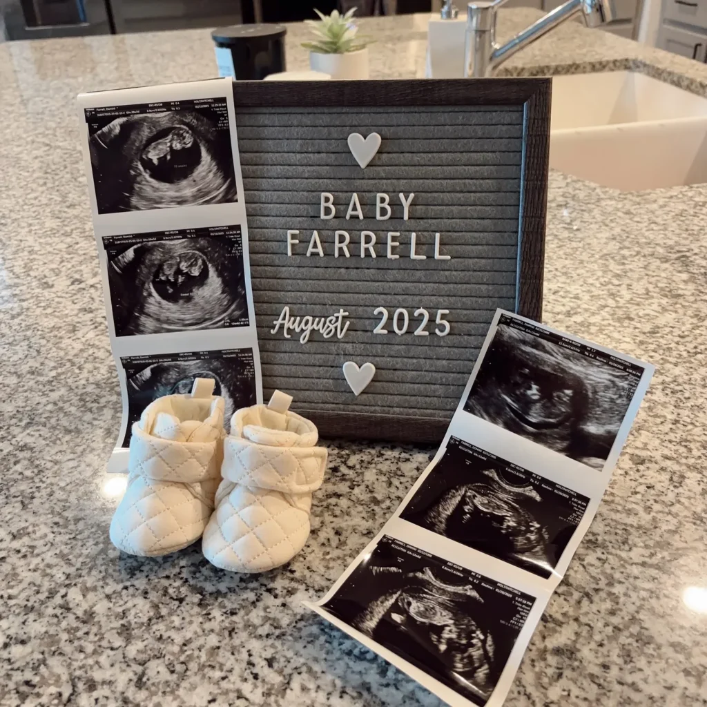 a baby ultrasound pictures and a sign on a marble counter