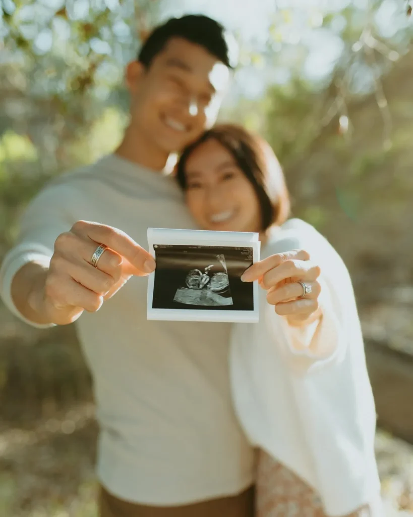 Holding up the ultrasound photo with big smiles makes for a heartfelt and timeless shot.